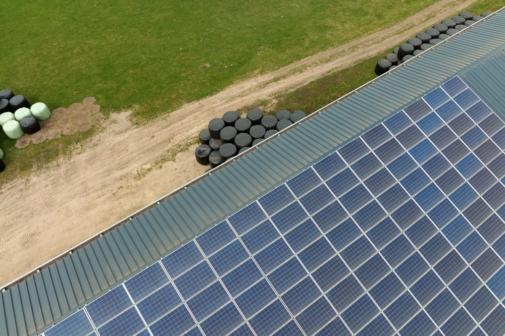 Aerial,View,Of,Blue,Photovoltaic,Solar,Panels,Mounted,On,Farm